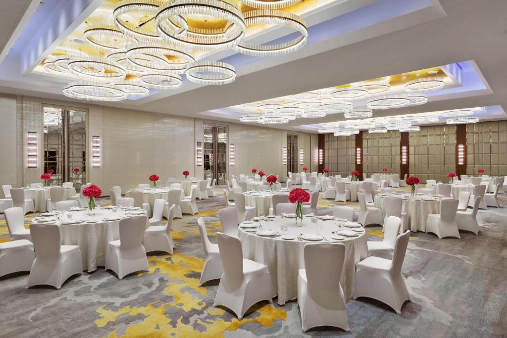 a banquet hall with white tables and white chairs at Hyatt Regency Riyadh Olaya in Riyadh