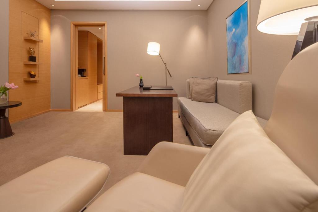 a living room with a couch and a table at Hyatt Regency Riyadh Olaya in Riyadh