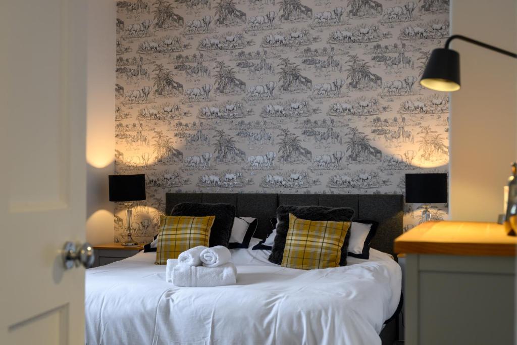 a bedroom with a bed with two towels on it at Sandyhill, St. Andrews in Fife
