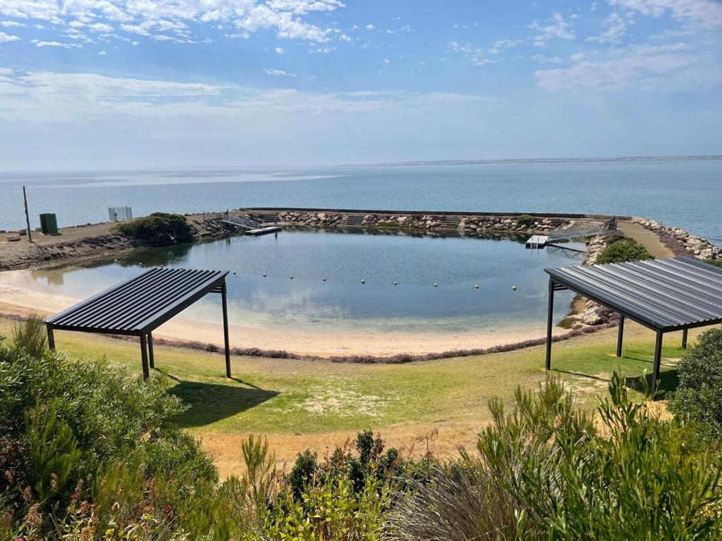 a large pool of water next to a beach at Jack's Tidal Pool Shack in Kingscote