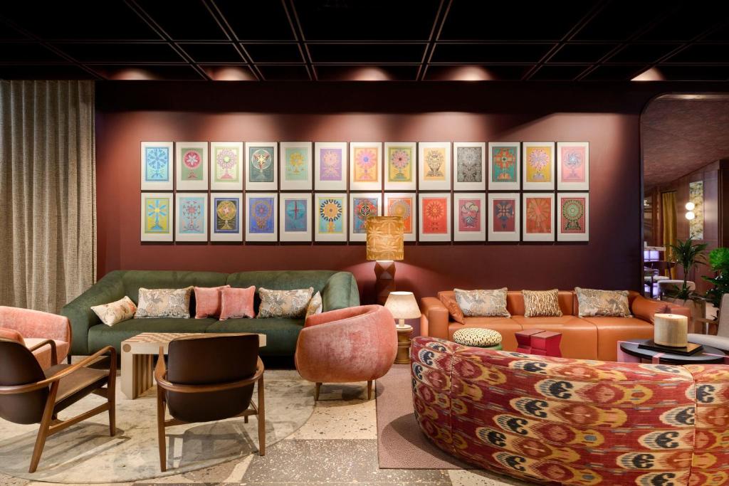a living room with couches and chairs at Skald Hotel Akureyri, Curio Collection By Hilton in Akureyri