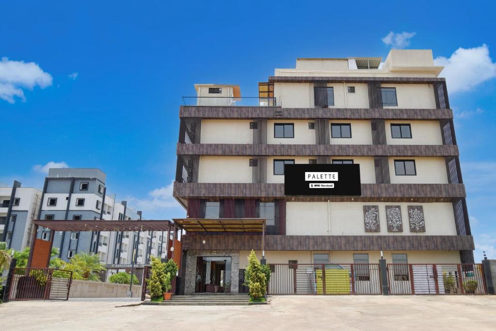 a building with a sign on the side of it at Palette Mahbubabad Railway Station Formerly Hotel RC Platinum in Mahbūbābād