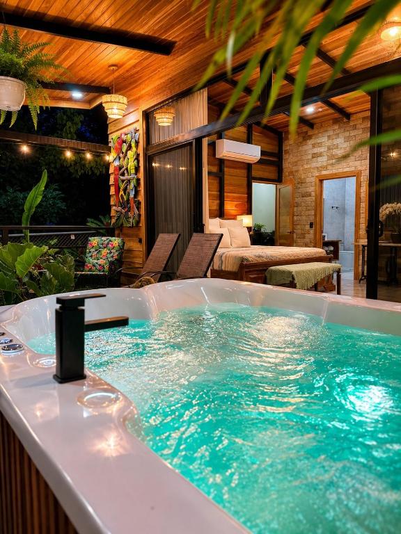 a jacuzzi tub in the middle of a room at Arenal Rain Forest Lodge in Fortuna