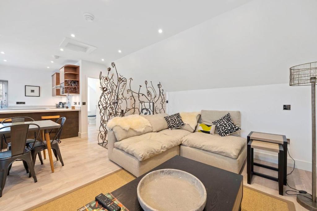 a living room with a couch and a table at Grange Cottage in Galashiels