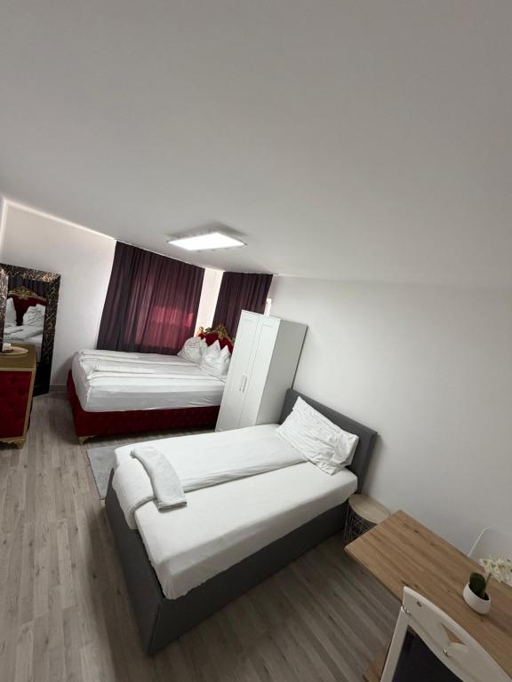 a room with two beds and a couch in it at Zimmervermietung Wels in Wels