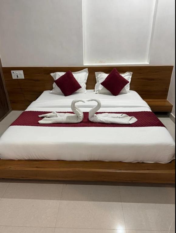 a bed with two swans on top of it at Deep residency in Bharatpur