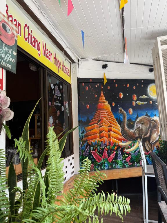 a store front with a painting of a temple at Baan Chiang Maan in Chiang Mai