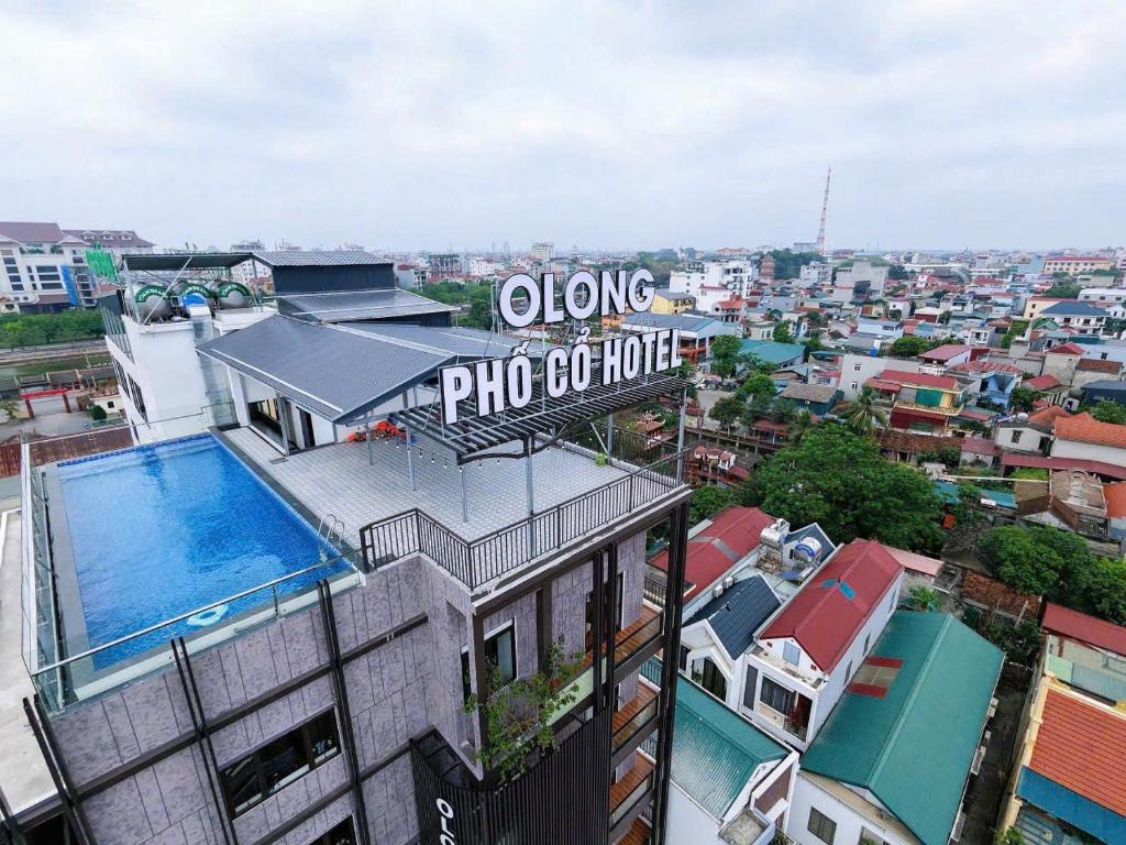 a building with a swimming pool on top of it at Olong Pho Co Hotel Ninh Binh in Kỳ Vĩ