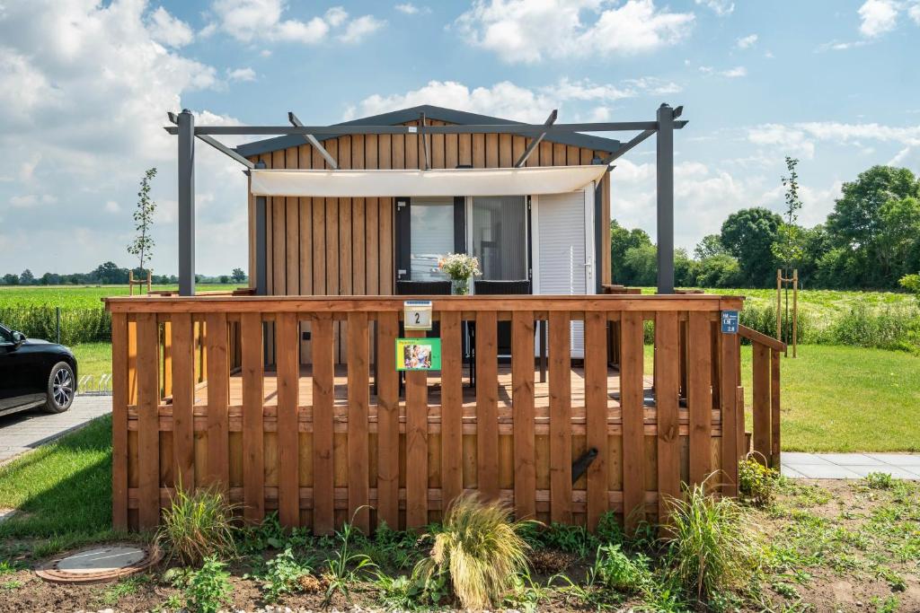 a tiny house with a wooden fence at Rapunzel in Dörverden