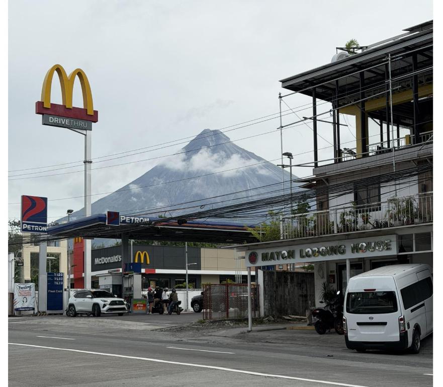 a mcdonalds restaurant with a mountain in the background at Mayon Lodging House in Legazpi