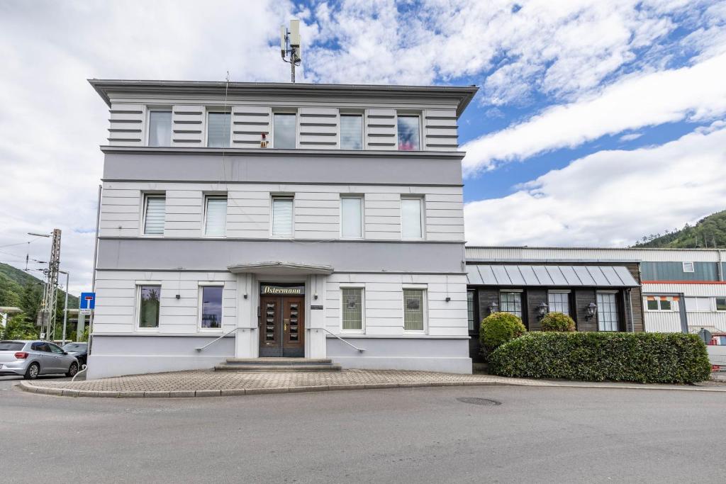 a white building with a clock tower on top at Ferienwohnung Ostermann in Plettenberg