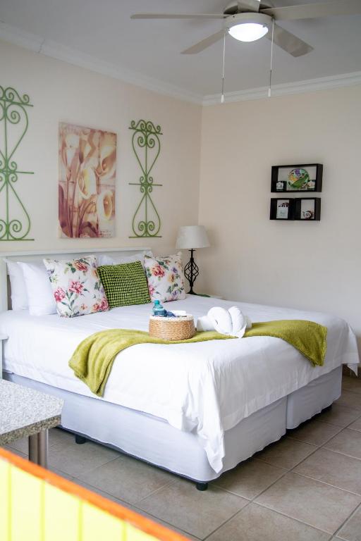 a bedroom with a large white bed in a room at @47 Guest House in Gqeberha