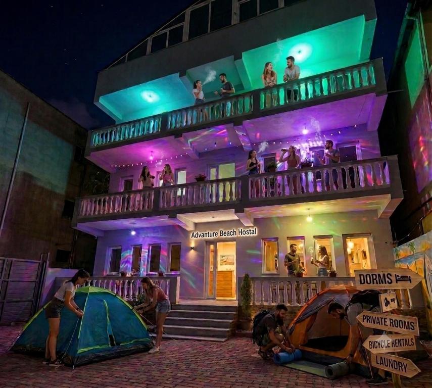 a group of people standing on the balcony of a building at Adventure Beach Hostal in Durrës