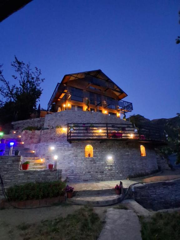 a building with a dome on top at night at Villa Sajmo in Koman