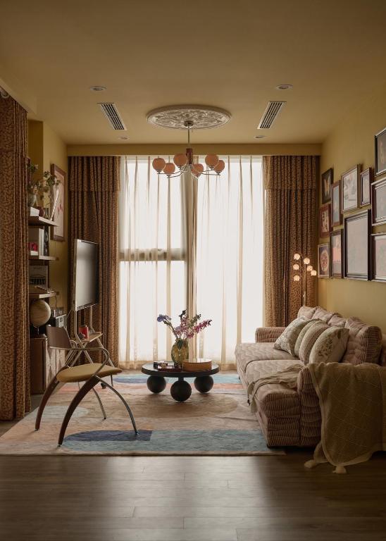 a living room with a couch and a large window at LangX Ecopark Sky Forest - Dolce Apartment in Kim Quan