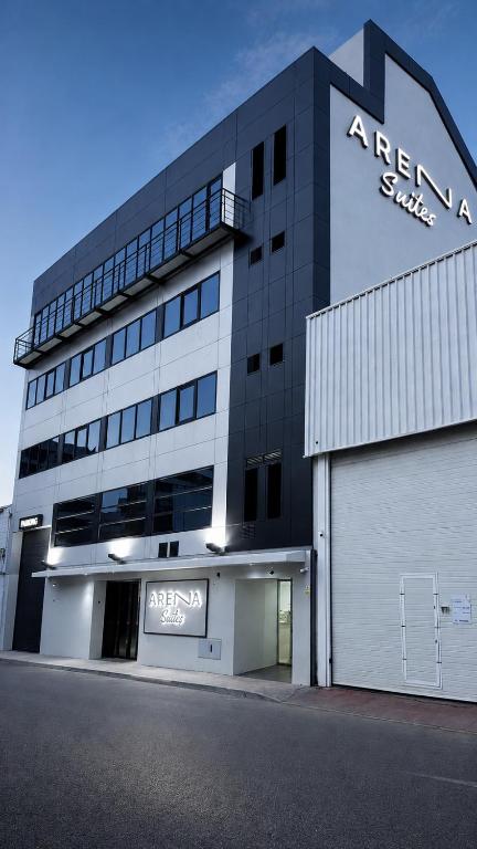 a large building with a sign on the side of it at Arena Málaga Suites in Málaga