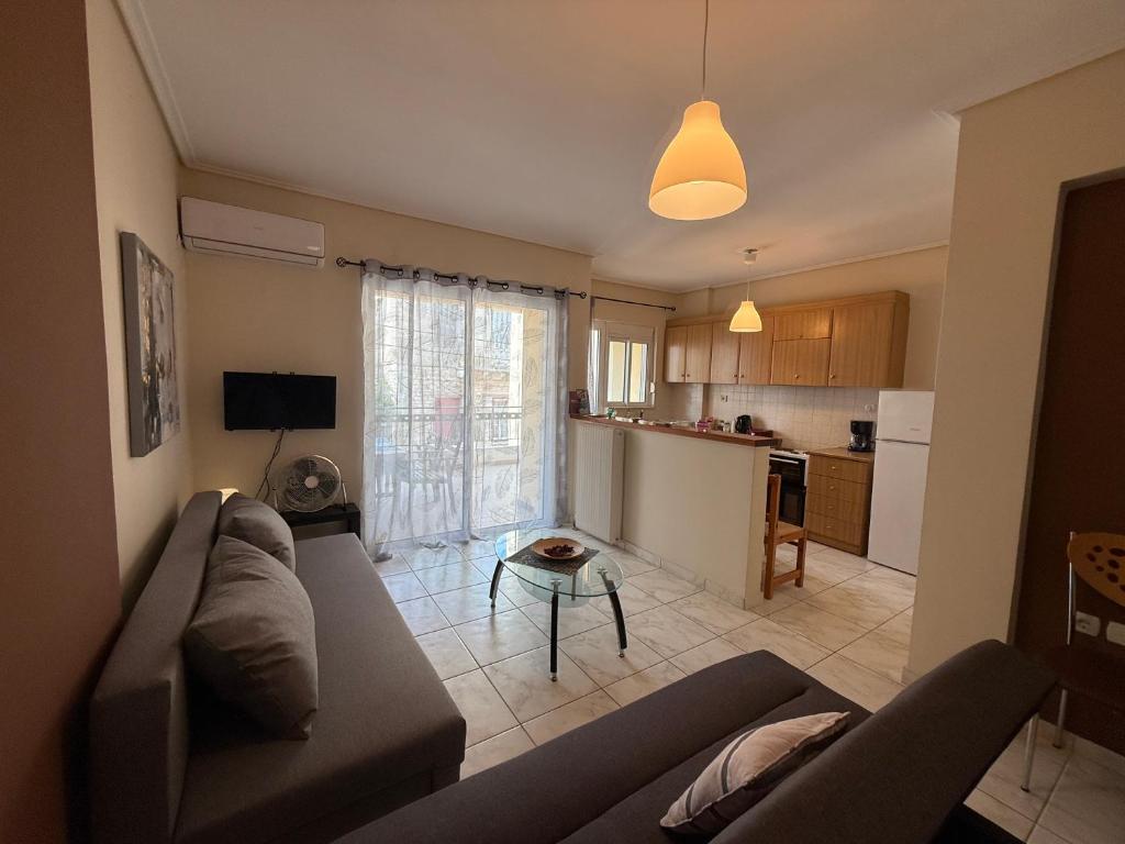 a living room with a couch and a table at Alasrooms A1 in Missolonghi
