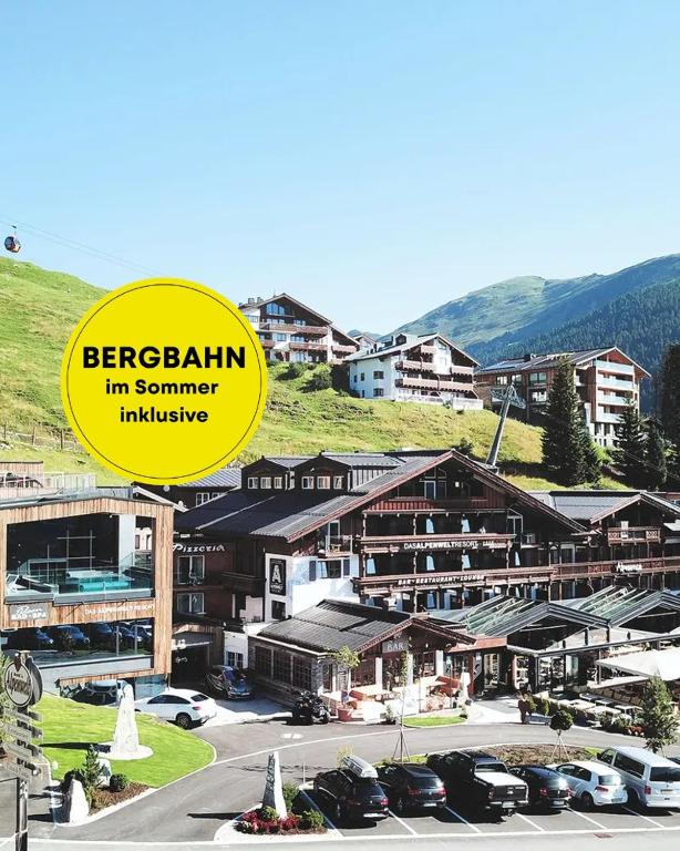 a yellow sign that reads bergeralam im summer inclusive at MY ALPENWELT Resort in Königsleiten