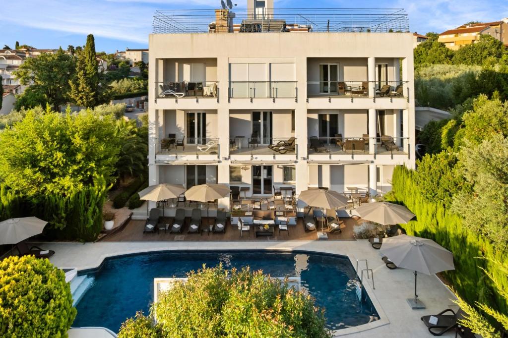 an aerial view of a hotel with a pool and umbrellas at Modern Rooms Villa Oasiss by Istrabook in Pula