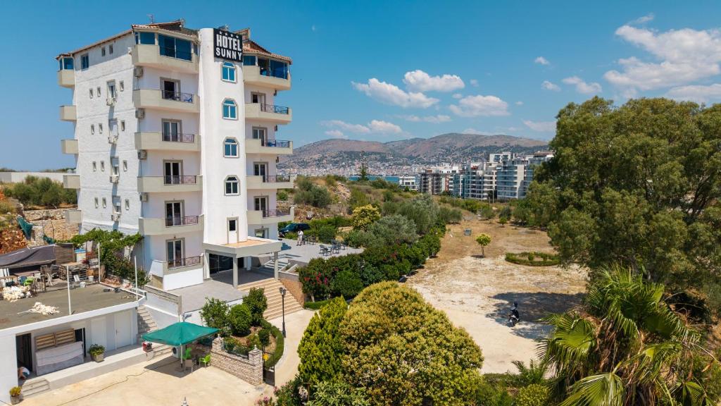 an apartment with a view of a building at Sunny Hotel in Sarandë