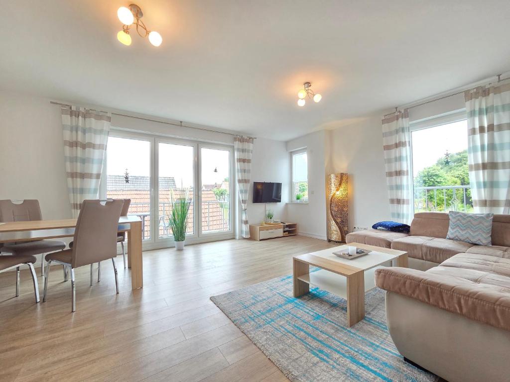 a living room with a couch and a table at Nr 57 - Ferienwohnung Mühlenstraße in Carolinensiel