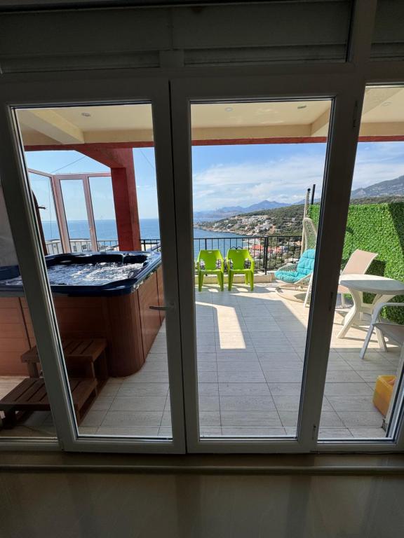 a view from the balcony of a house with a tub at SunsetEscape Apartments Utjeha in Utjeha