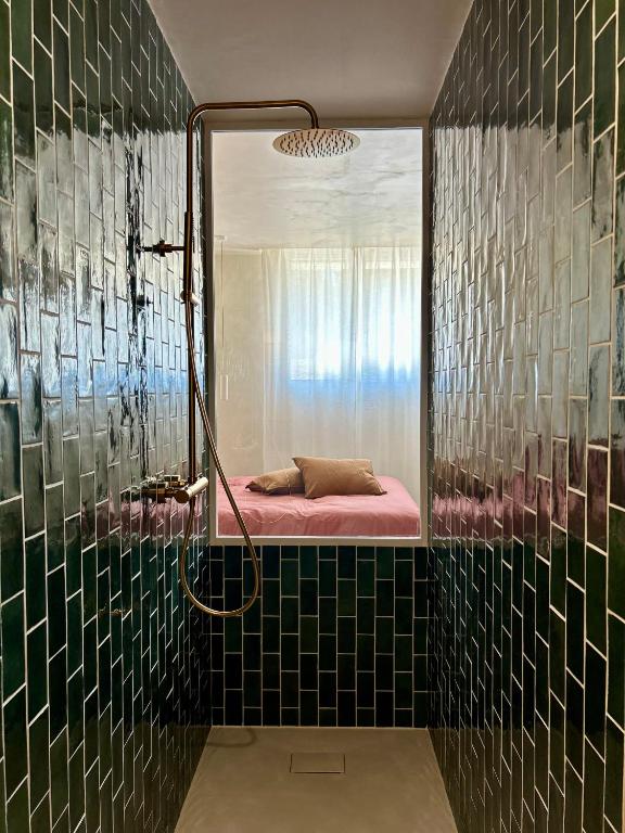 a bathroom with a shower with a bed in it at Bulle de détente - Proche Disney in Villiers-sur-Morin