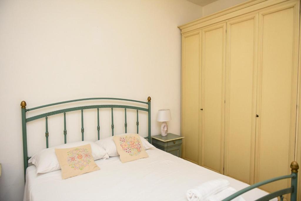 a bedroom with a bed with two pillows on it at Casa Isabella in Nuoro
