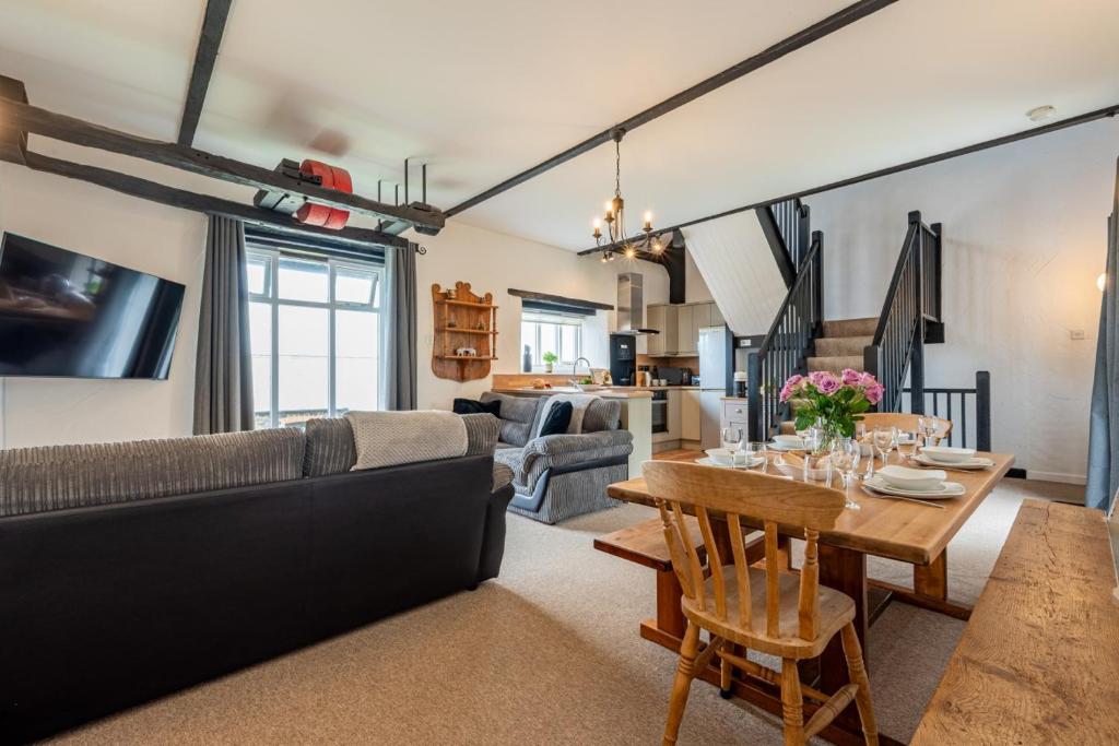 a living room with a couch and a table at Duchy - Treworgie Barton Cottages in Bude