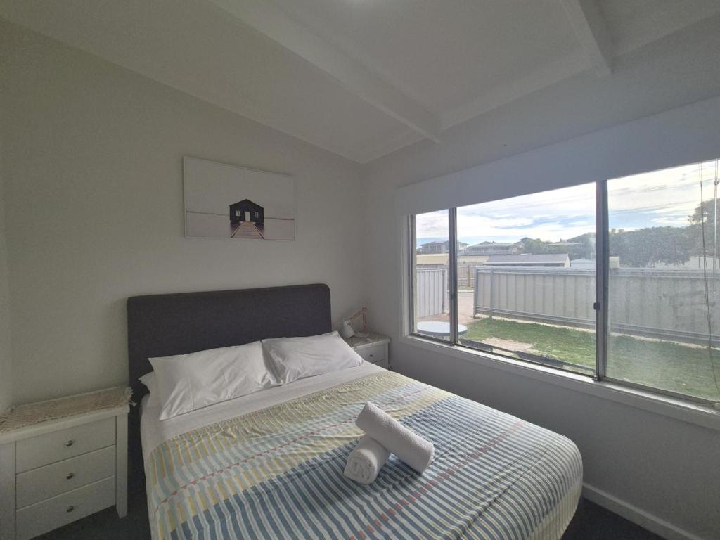 a bedroom with a bed and a large window at Esperance Little Units 3 in Esperance