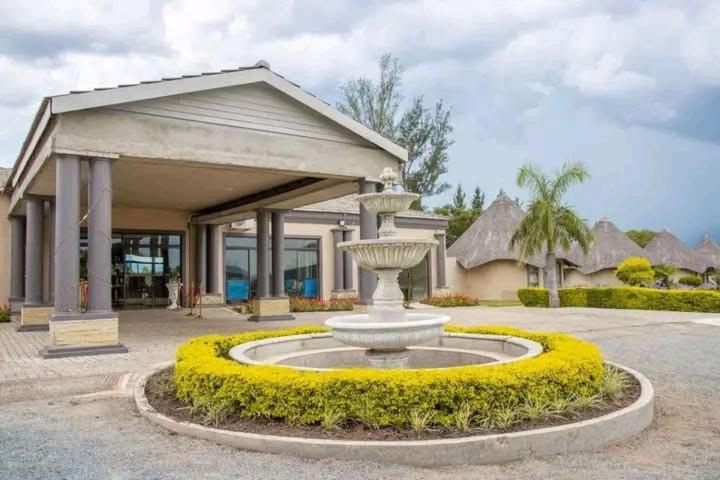 a large fountain in front of a building at Radiant Resort in Manzini