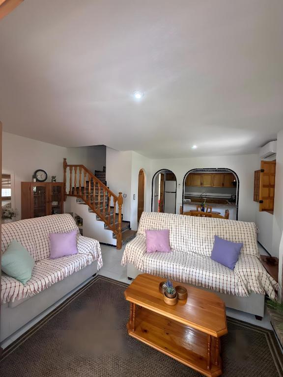 a living room with two couches and a table at Casa en la playa con piscinas in Gran Alacant