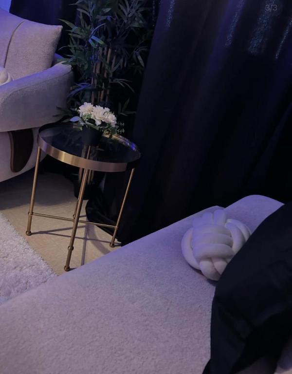 a hand laying on a bed next to a side table at Faith hot in Courcouronnes