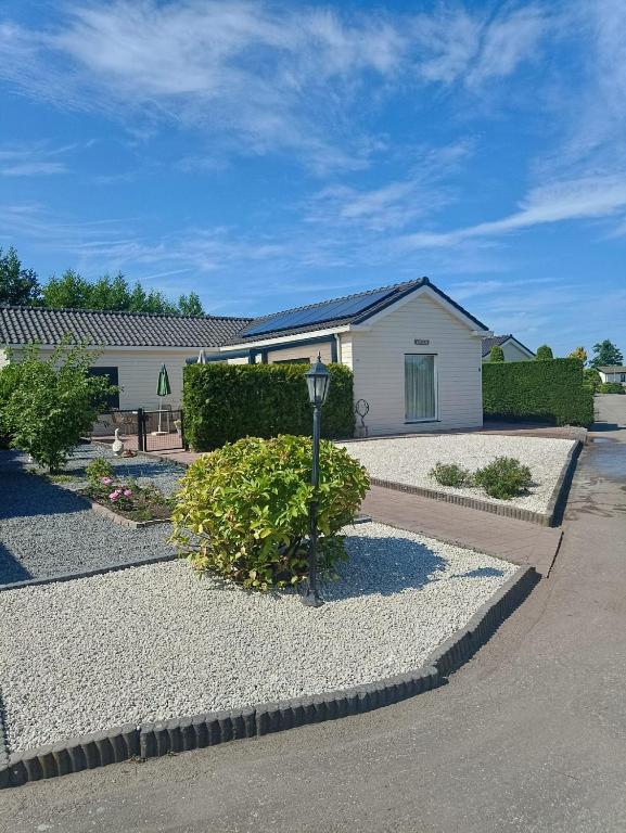a house with a gravel driveway in front of it at KRAB160 in Sint Annaland
