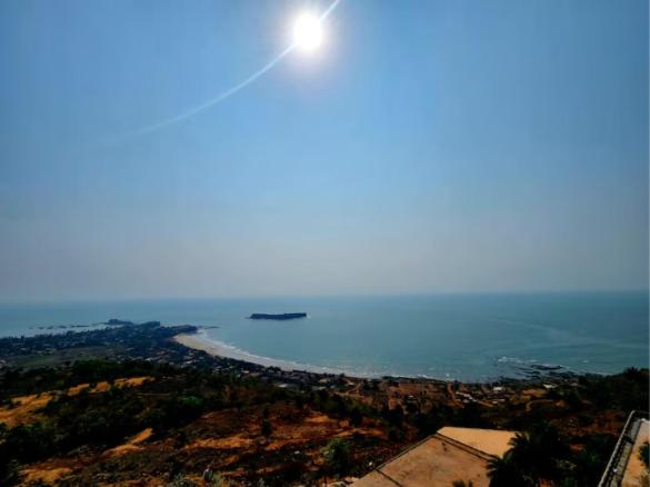 a view of the ocean with a boat in the water at Regenta Waterfront Resort, Dapoli in Dapoli