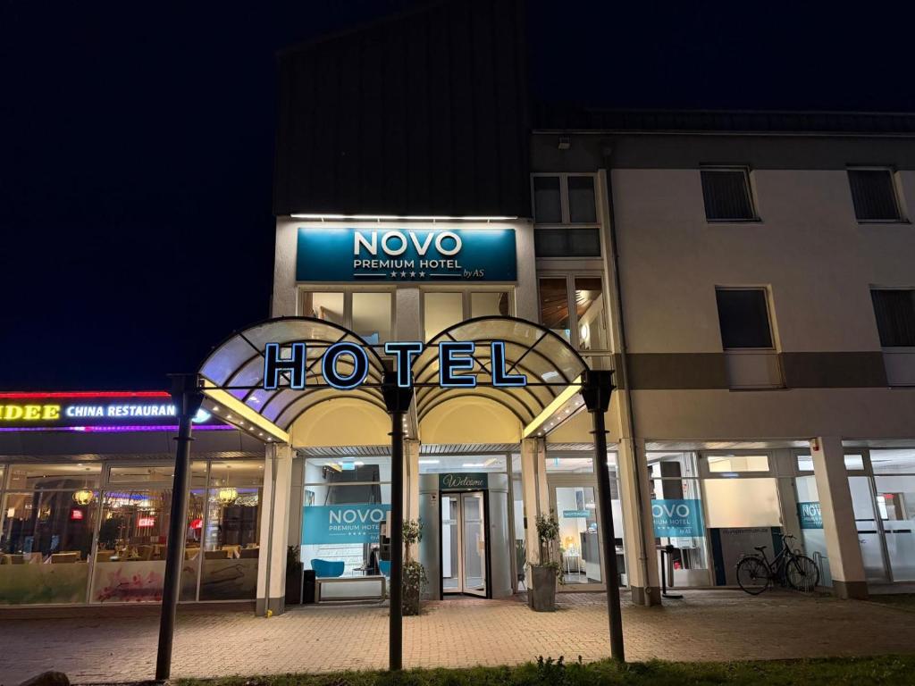 a hotel sign in front of a building at night at Novo Premium Hotel by AS in Göttingen