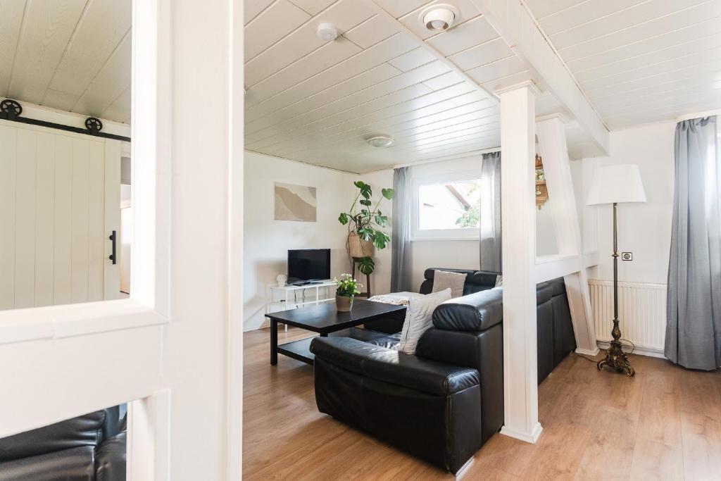 a living room with a couch and a table at Ferienhaus Steinhoff in Marsberg