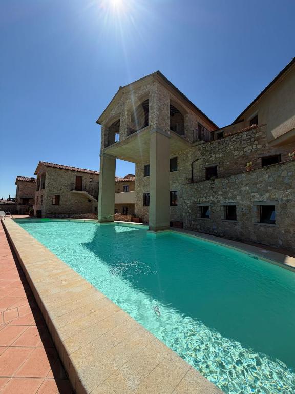 a swimming pool in front of a building at Chianti Borgo 28 in Gaiole in Chianti
