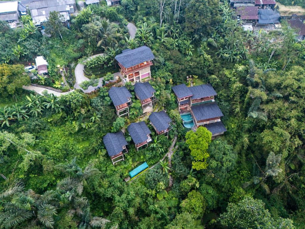 an aerial view of a house in the forest at Harsa Sanctuary by GenuineHost in Ubud
