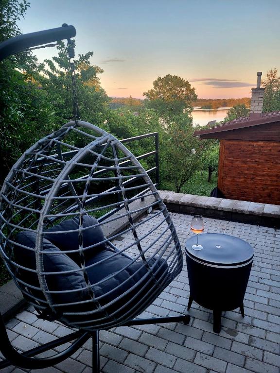 a circular swing sitting on a patio with a table at Broumík - chata s výhledy in Opočno