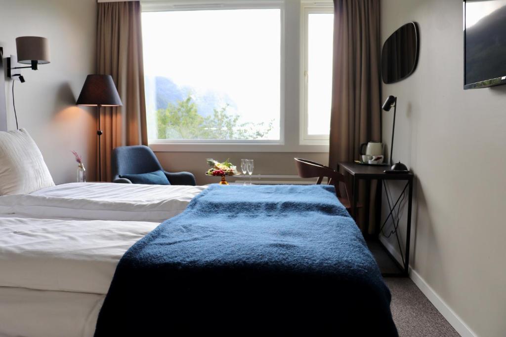 a hotel room with two beds and a window at Sirdalsvatnet Hotel in Sirdal in Tonstad