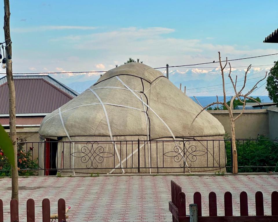 a large dome building with a fence in front of it at Nomad Garden Camp in Cholpon-Ata