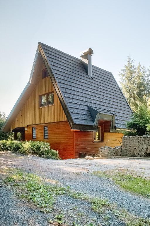 a log cabin with a black roof at Chata u lesa in Prostřední Bečva