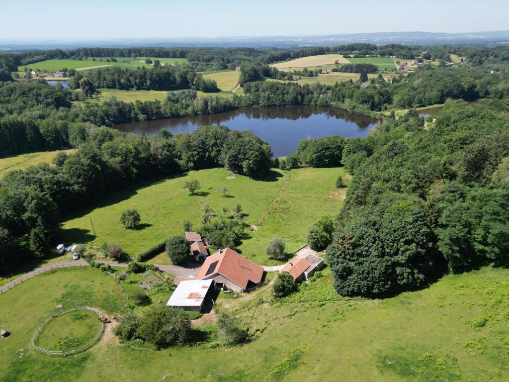 an aerial view of a house with a lake at Gîte du Mont Gérard in La Lanterne-et-les-Armonts