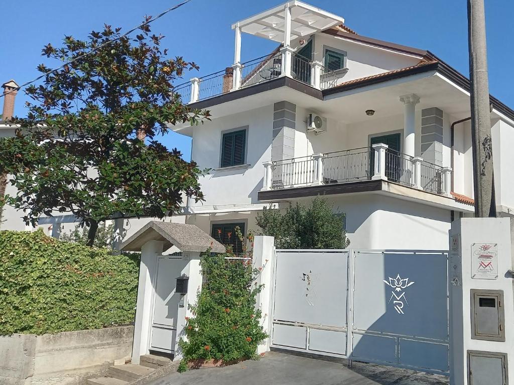 a white house with a white gate and a fence at B&B TENUTA BIANCA in Oliveto Citra