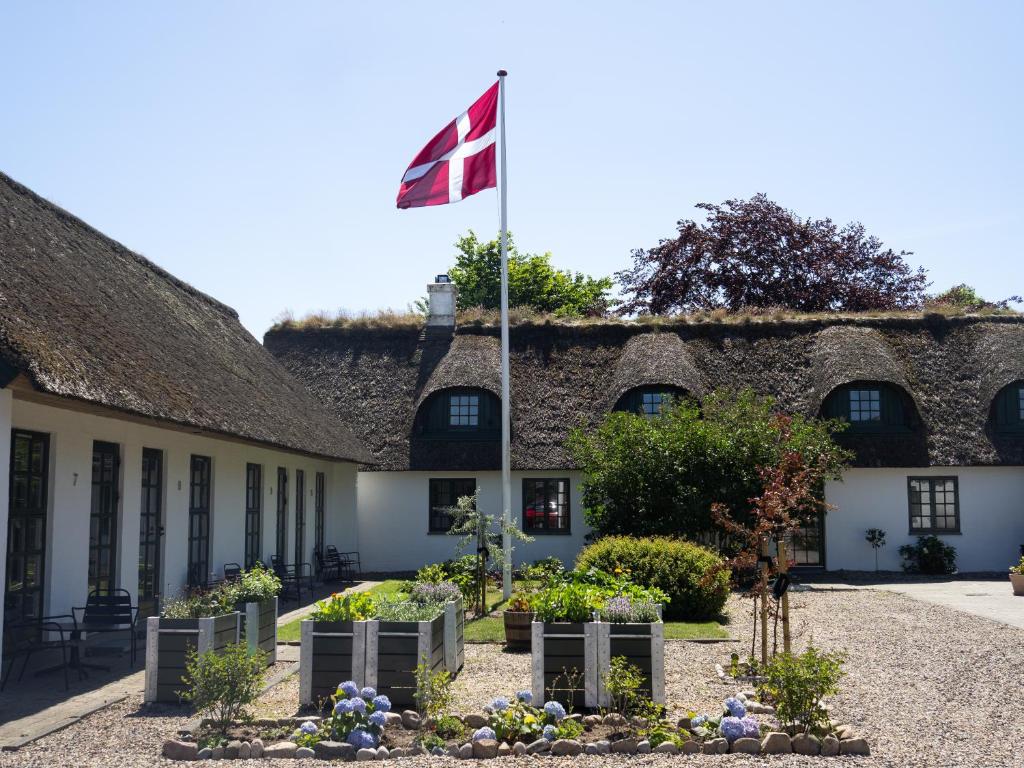 a flag flying in front of a building at Nørby Boutique Hotel in Fanø