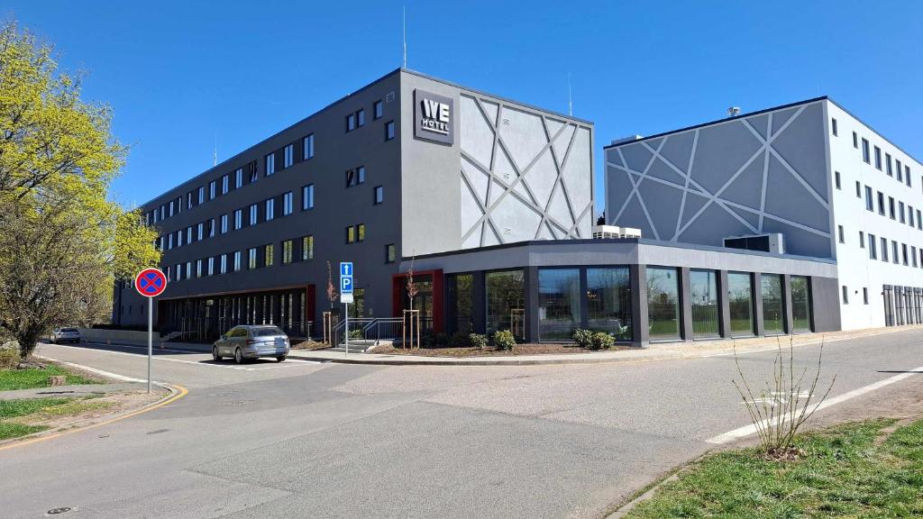 a large building with a car parked in front of it at WE Hotel EXPO Prague in Prague