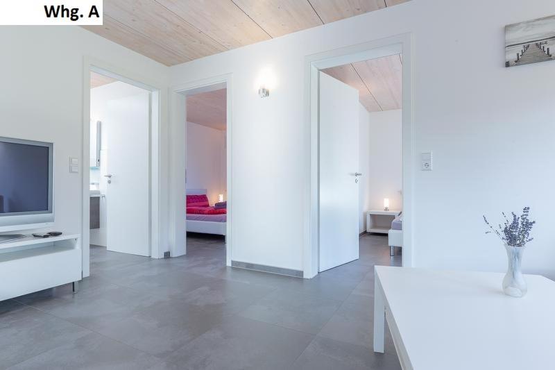 a white living room with a television and a couch at Ferienwohnung Philip in Meersburg