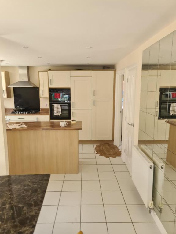 a large kitchen with a counter and a microwave at FV Dwelling in Nottingham