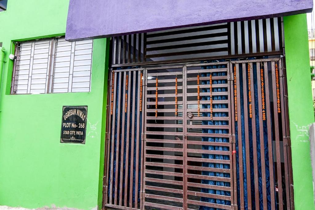 a green building with a gate and a sign on it at Hotel O Star light in Bhubaneshwar